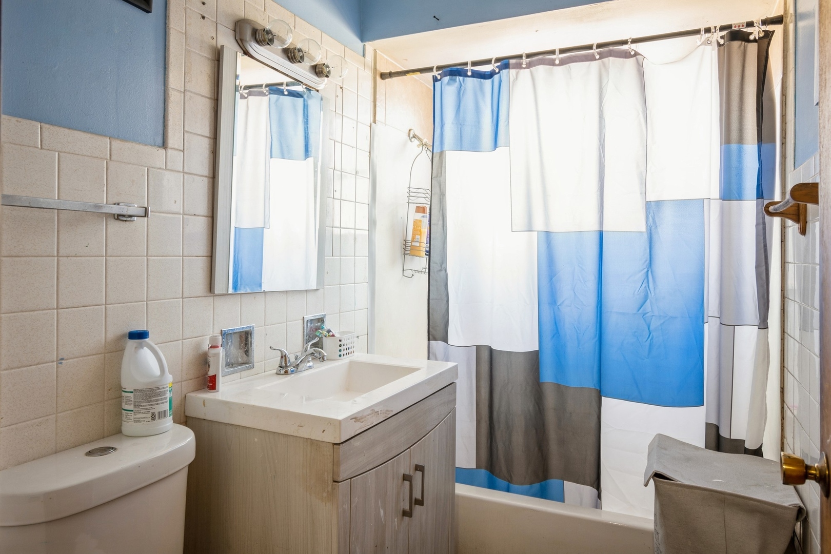 14321 Normal Avenue Harvey, IL 60426 - Photo 8 of 9 a bathroom with a sink a mirror and a shower curtain