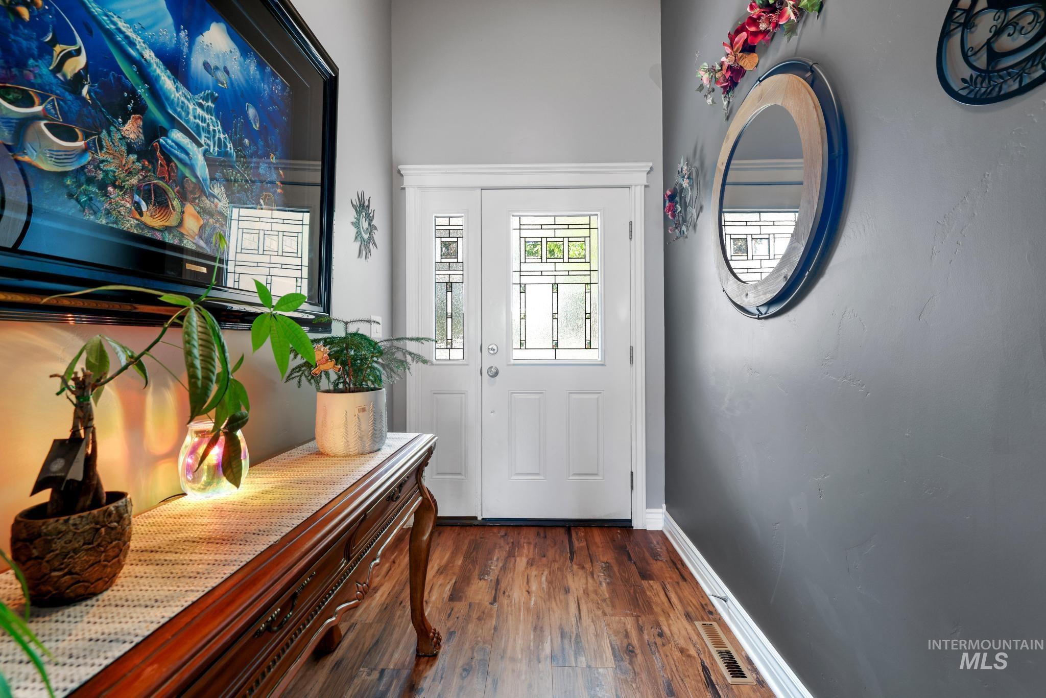 467 Wildrose Loop Twin Falls, ID 83301 - Photo 6 of 46 Entryway featuring a white door with transom and sidelight windows, dark wood-finish flooring, and light gray wall paint