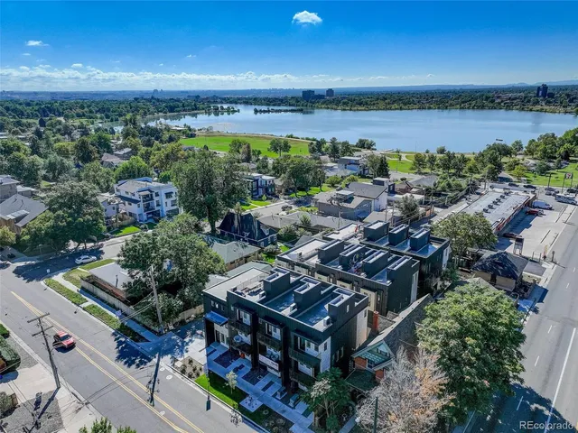 an aerial view of a house with a yard and lake view