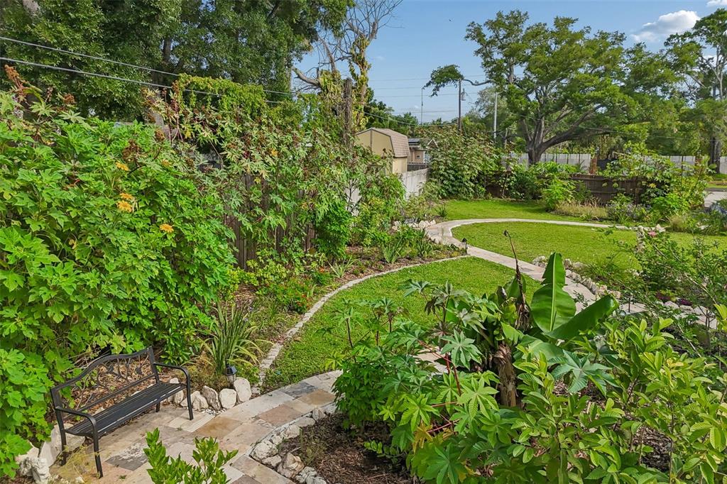 1875 Belleair Road Clearwater, FL 33764 - Photo 98 of 100 a view of a garden with a bench