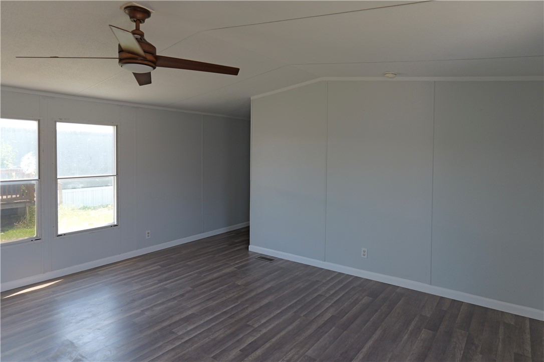 732 C Rogers Street Normangee, TX 77871 - Photo 3 of 10 a view of an empty room with wooden floor and a window