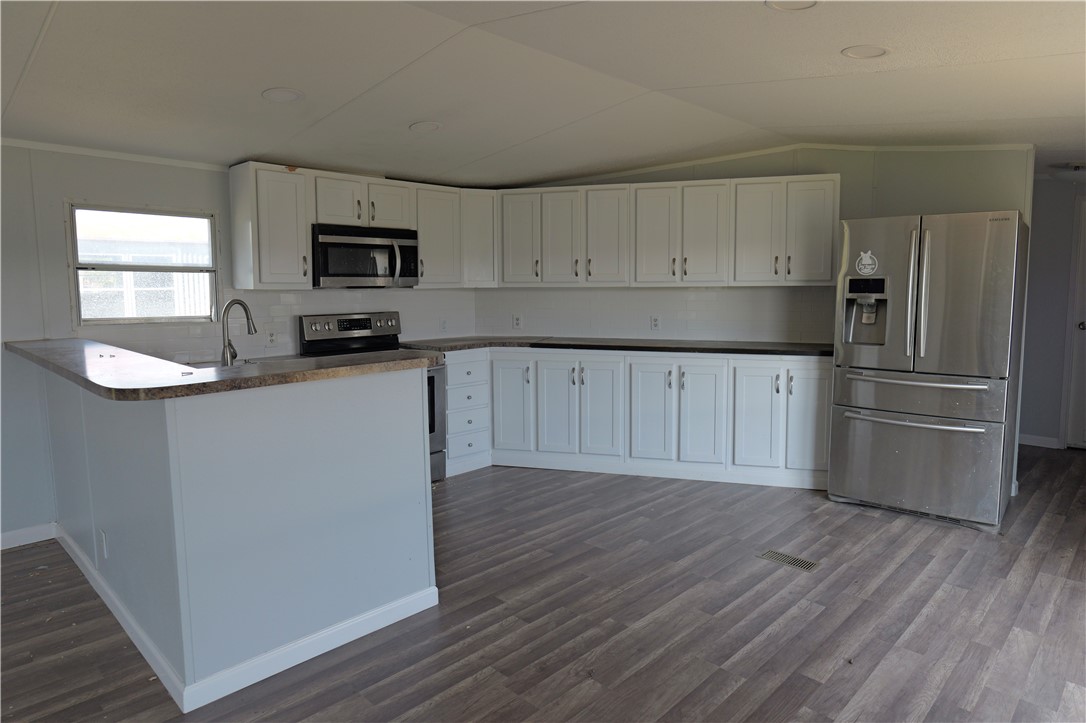 732 C Rogers Street Normangee, TX 77871 - Photo 4 of 10 a kitchen with granite countertop a refrigerator stove top oven and sink