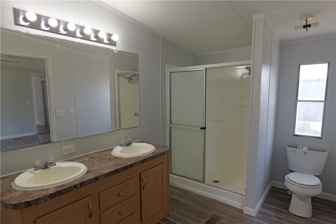 732 C Rogers Street Normangee, TX 77871 - Photo 8 of 10 a bathroom with a granite countertop sink toilet and shower