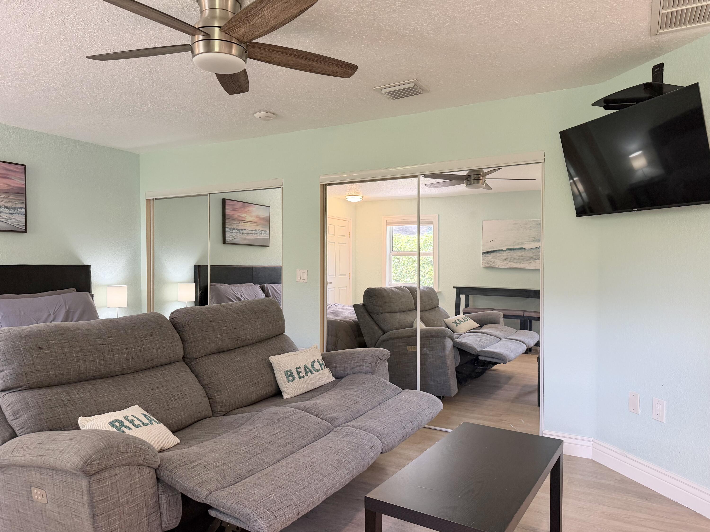 6100 Francis Street, Unit B Jupiter, FL 33458 - Photo 7 of 19 a living room with furniture and a flat screen tv