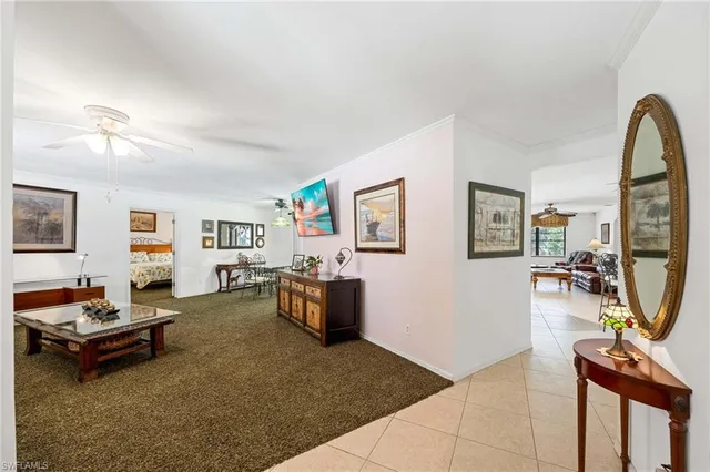 a large kitchen with stainless steel appliances granite countertop a stove a sink dishwasher a refrigerator white cabinets and wooden floor