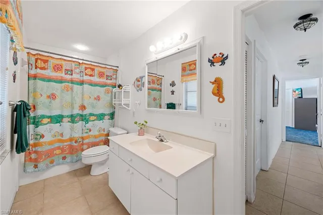a bathroom with a sink mirror vanity and shower