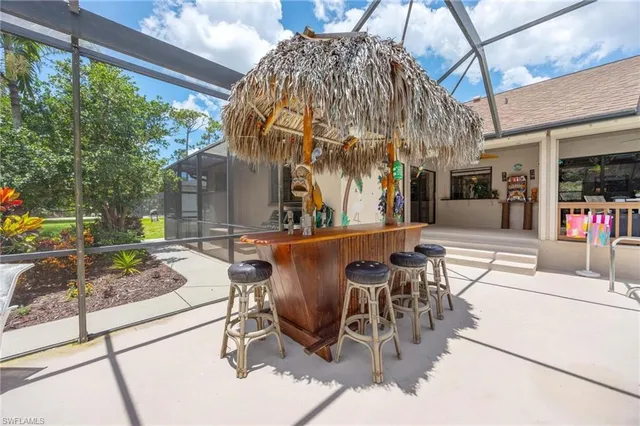 a view of a patio with couches table and chairs and potted plants