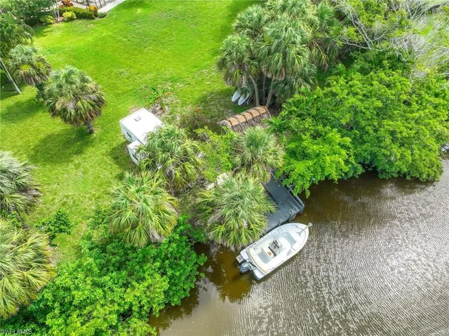 a view of a lake with a patio and swimming pool