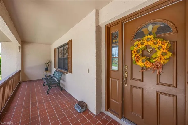 a view of a hallway with wooden floor and a potted plant
