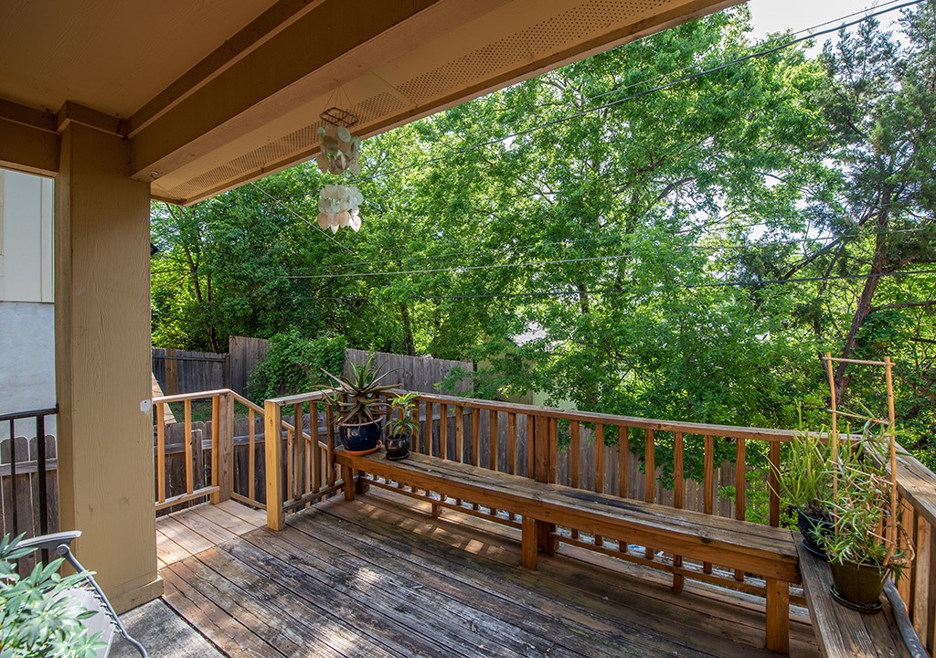 3609 Clawson Road, Unit A Austin, TX 78704 - Photo 12 of 17 A spacious outdoor deck with a built-in bench overlooks a wooded private yard, perfect for relaxation.