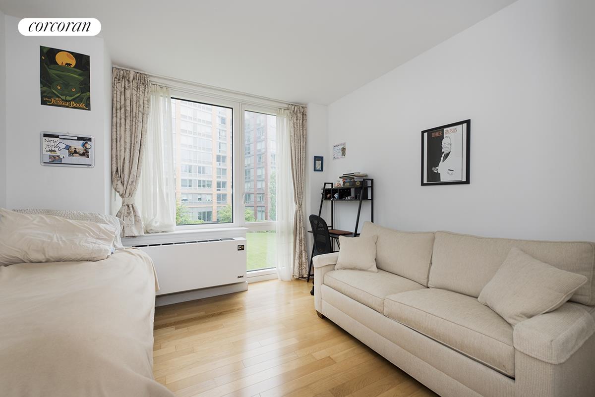 415 Main Street, Unit 2F Manhattan, NY 10044 - Photo 14 of 18 a living room with furniture and a window