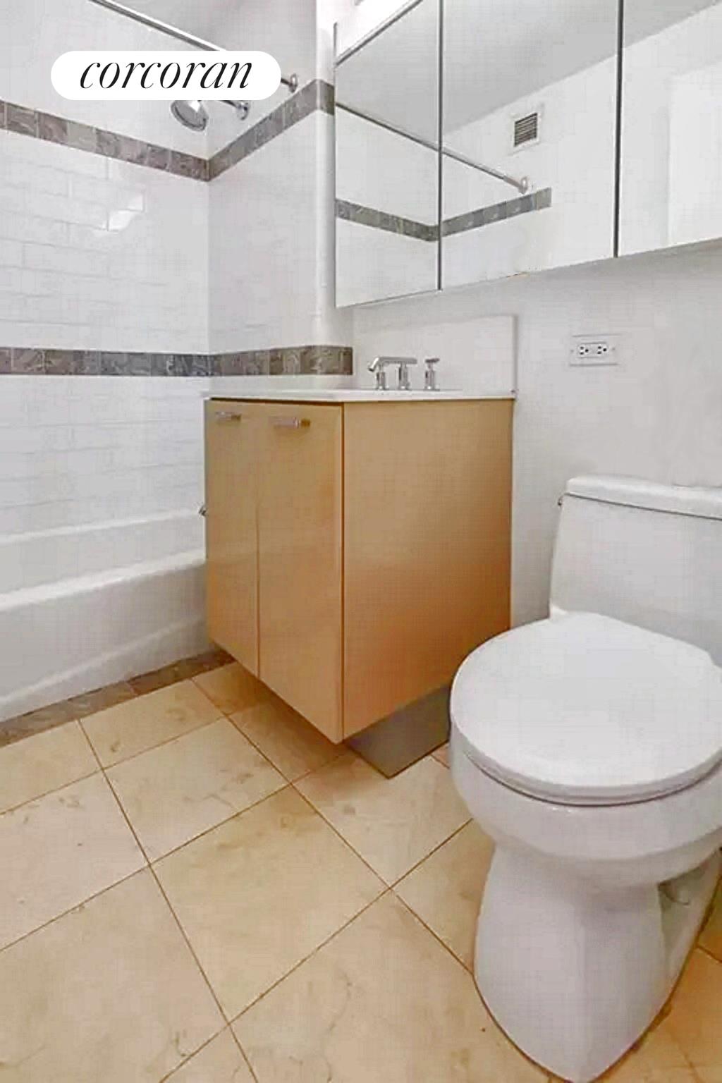 415 Main Street, Unit 2F Manhattan, NY 10044 - Photo 16 of 18 a bathroom with a toilet and a bathtub