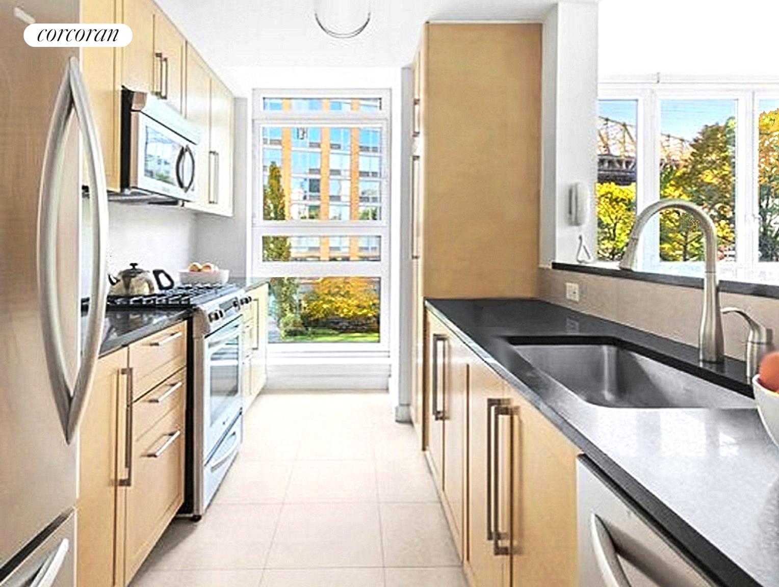 415 Main Street, Unit 2F Manhattan, NY 10044 - Photo 9 of 18 a kitchen with granite countertop a refrigerator and a sink