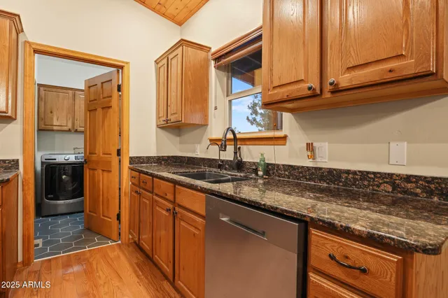 a kitchen with stainless steel appliances granite countertop a sink and a stove
