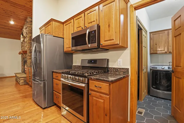 a kitchen with stainless steel appliances granite countertop a stove and a refrigerator