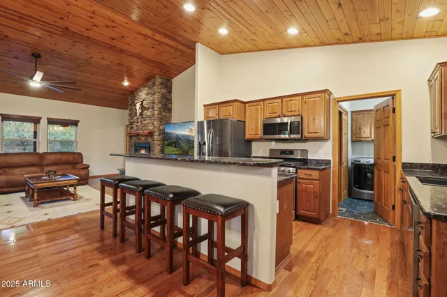 a kitchen with stainless steel appliances granite countertop a stove and a refrigerator