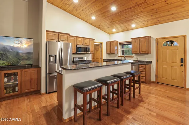 a kitchen with stainless steel appliances a refrigerator and microwave
