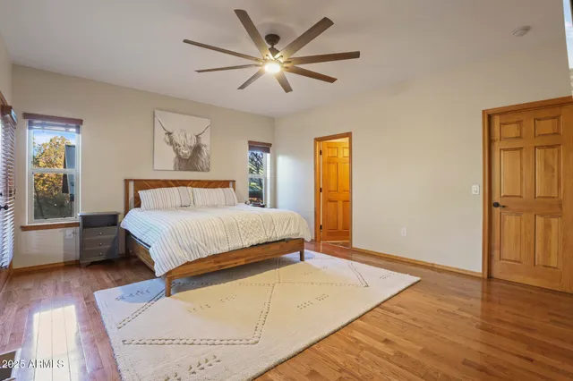 a bedroom with a large bed chandelier and a window