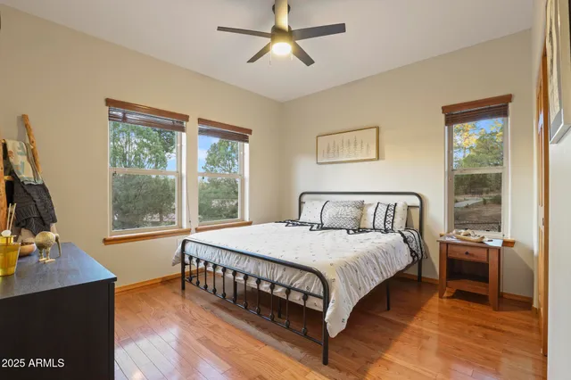 a bedroom with a bed window and a table