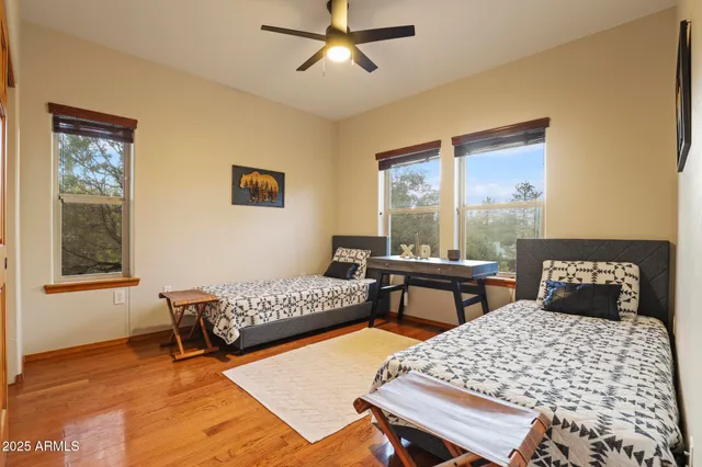 a bedroom with a bed window and a table