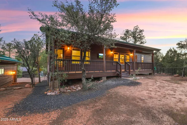 a view of a house with backyard and a tree
