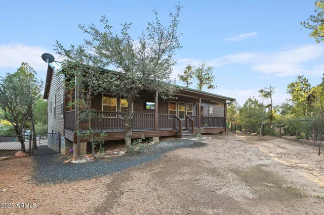 front view of a house with a tree in the background