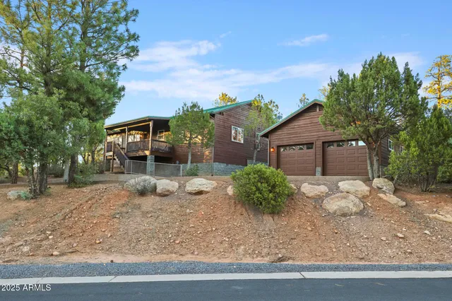 a front view of a house with garden and plants