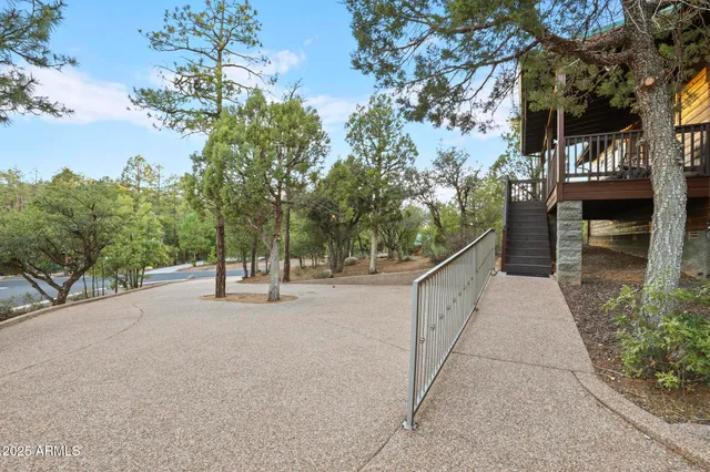a view of a pathway with a wrought fence