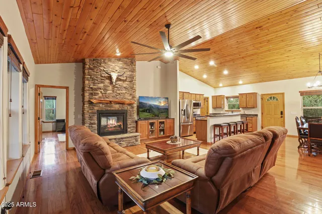 a living room with furniture a fireplace and a table