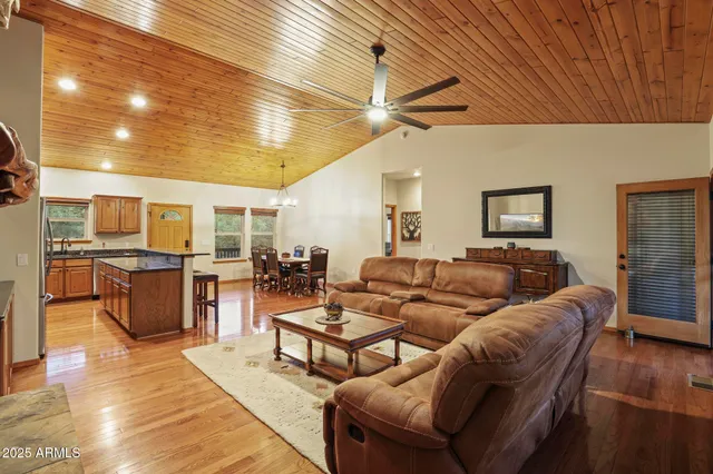 a living room with lots of furniture and kitchen view