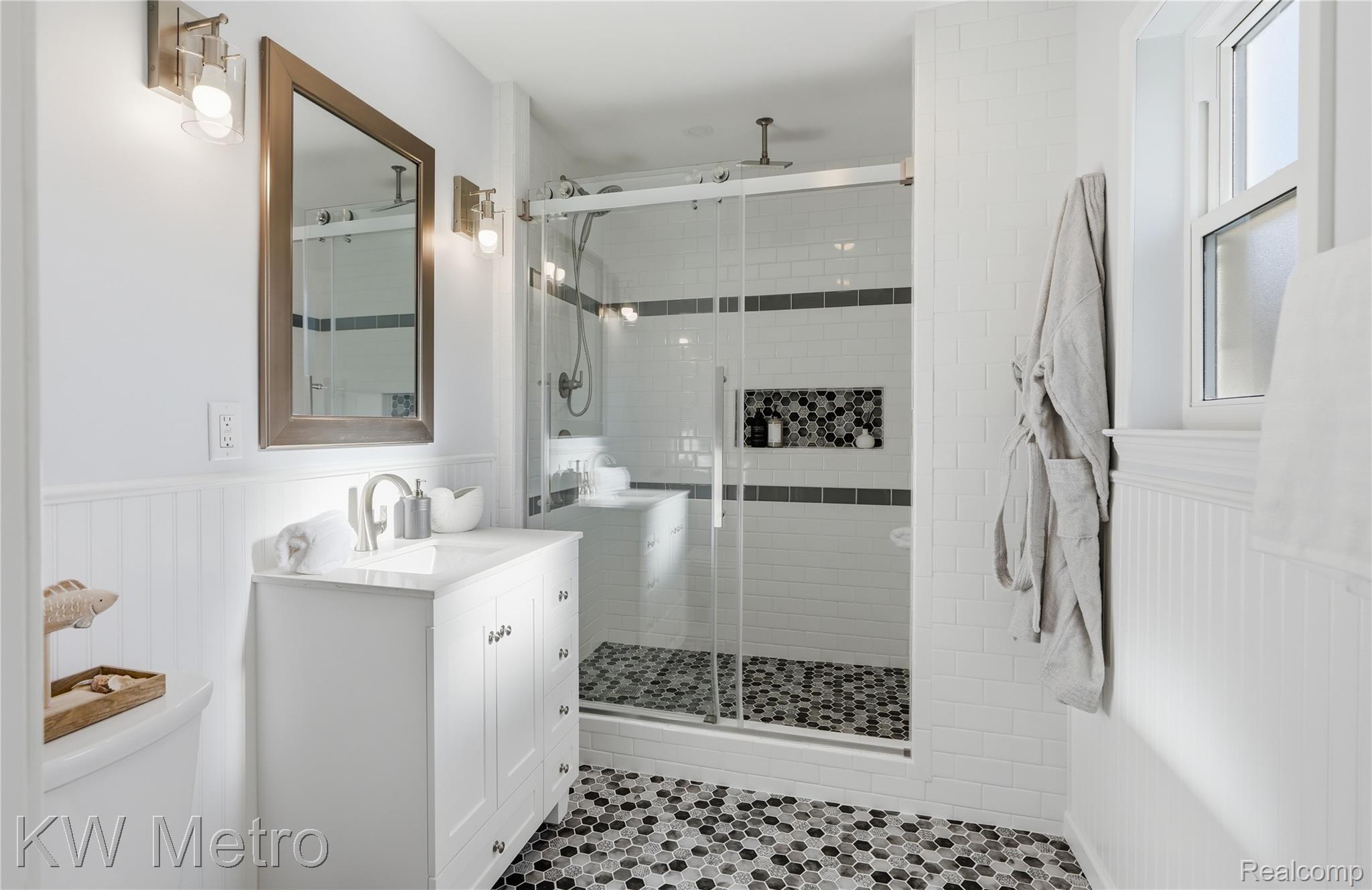 1861 Harvard Road Berkley, MI 48072 - Photo 12 of 27 Bathroom featuring vanity, a wainscoted wall, and a walk-in shower