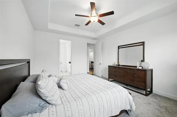 a bedroom with a bed window and a ceiling fan
