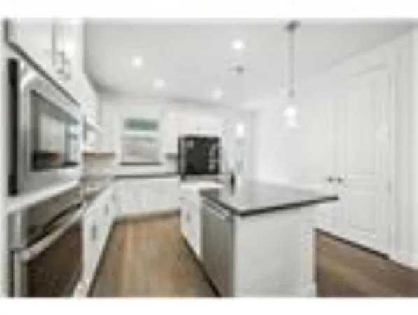 a kitchen with a sink and a stove top oven