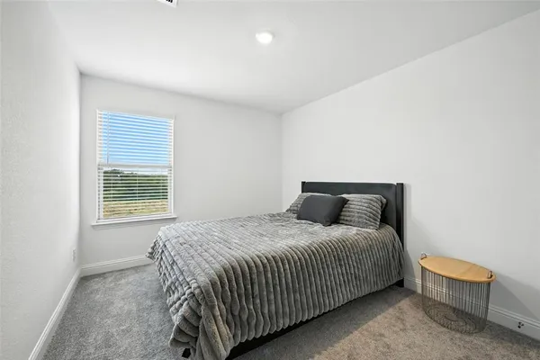 a bedroom with a bed and a chair