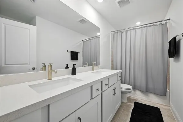a bathroom with a double vanity sink and mirror
