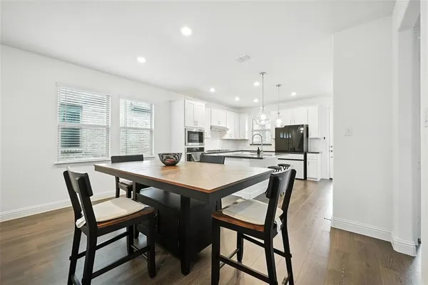 a view of a dining room with furniture and wooden floor