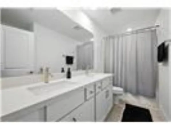 a bathroom with a sink a mirror and a shower