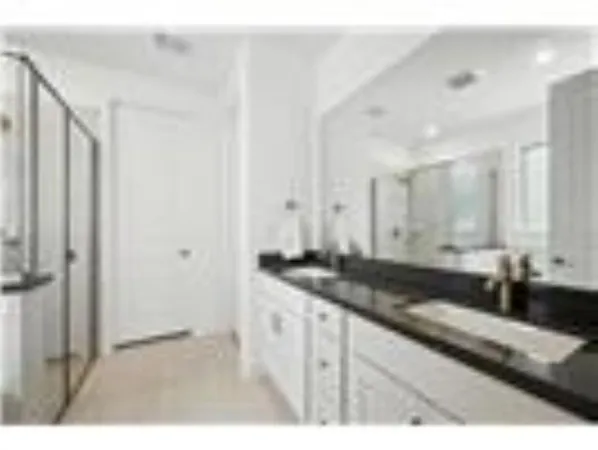 a bathroom with a double vanity sink and a mirror