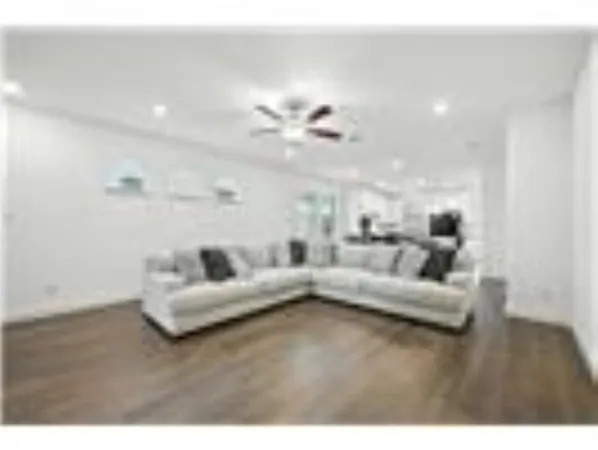 a view of living room with furniture and a ceiling fan