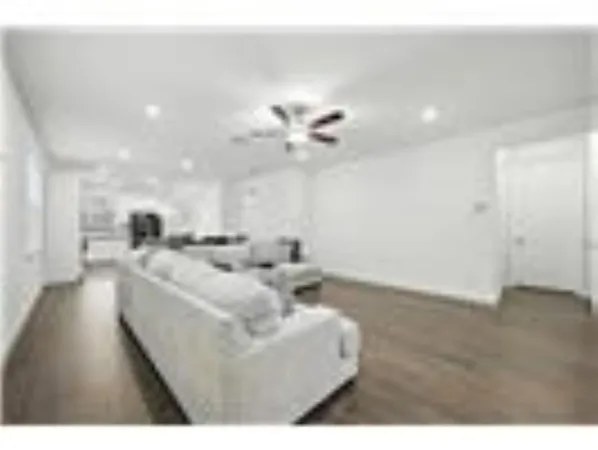 a living room with kitchen island furniture and a chandelier