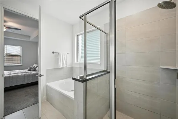 a bathroom with a tub sink and mirror