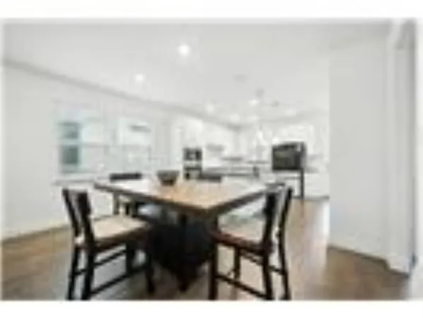 a dining room with furniture and a kitchen view