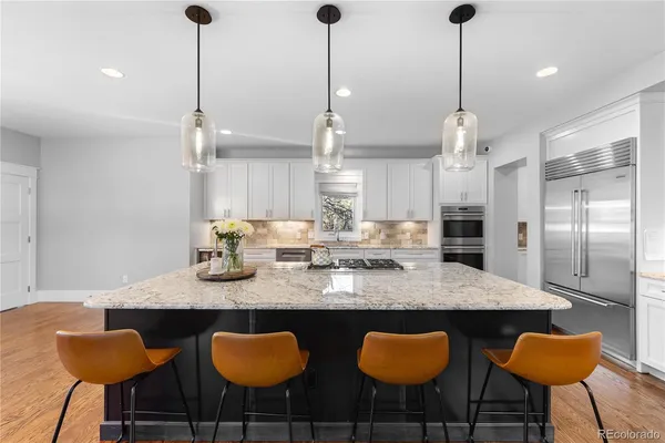 a kitchen with granite countertop a counter space furniture stainless steel appliances and cabinets