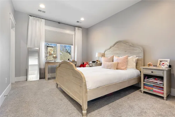 a bedroom with bed and a large window