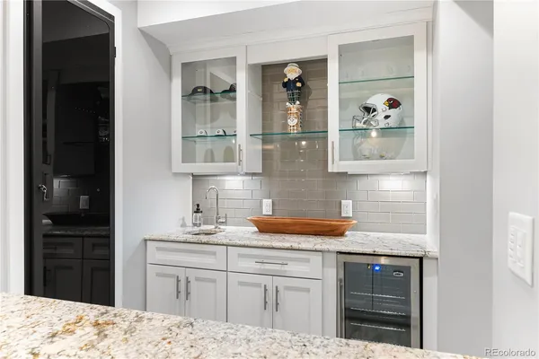 a kitchen with a refrigerator and cabinets