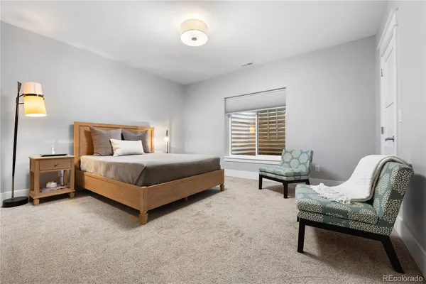 a bedroom with a bed and a couch