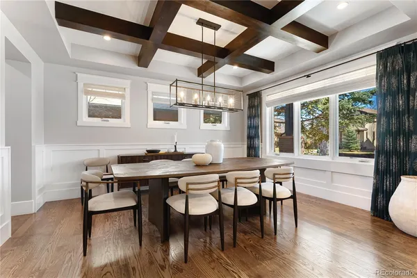 a dinning area with furniture window and wooden floor