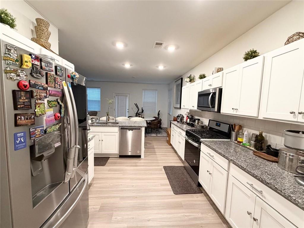 5790 Flint Lane Cumming, GA 30028 - Photo 11 of 40 a kitchen with stainless steel appliances granite countertop a refrigerator and a sink