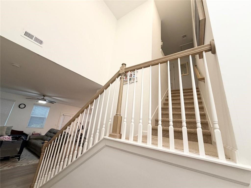 5790 Flint Lane Cumming, GA 30028 - Photo 21 of 40 a view of staircase with railing and a rug