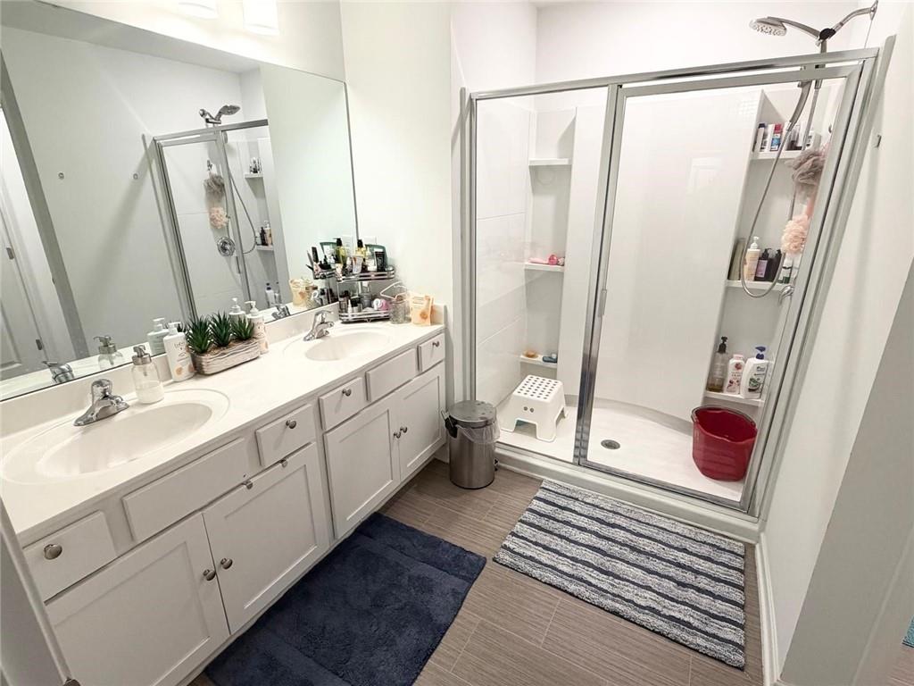 5790 Flint Lane Cumming, GA 30028 - Photo 22 of 40 a bathroom with a double vanity sink and mirror
